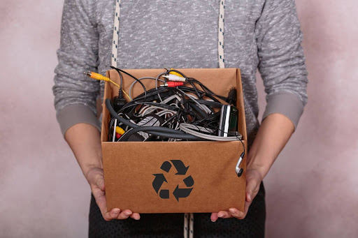 Electronics recycler box being held by a guy